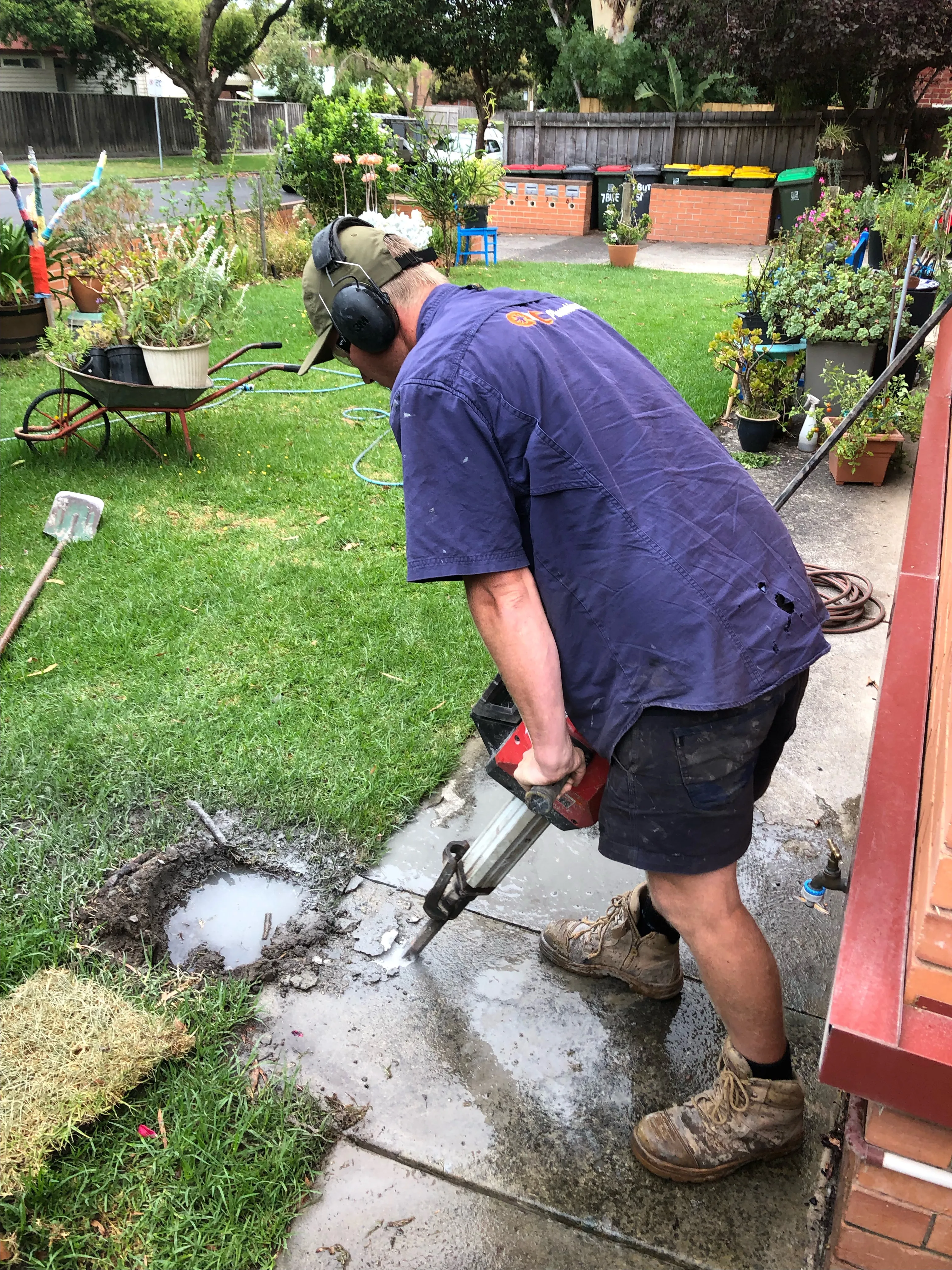 Breaking up concrete path to get to burst pipe under